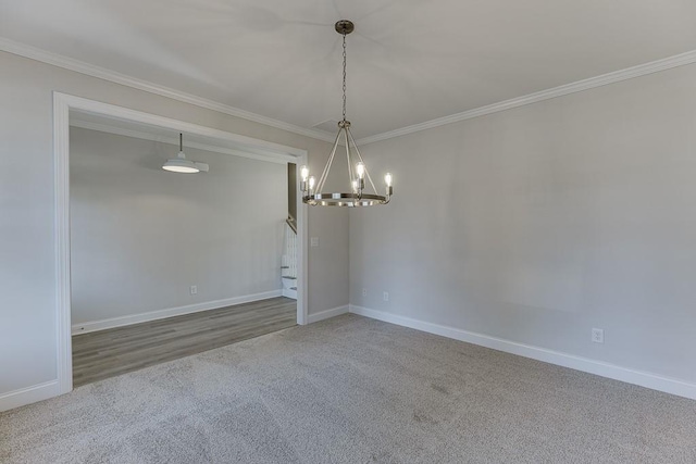 carpeted empty room with a chandelier and crown molding