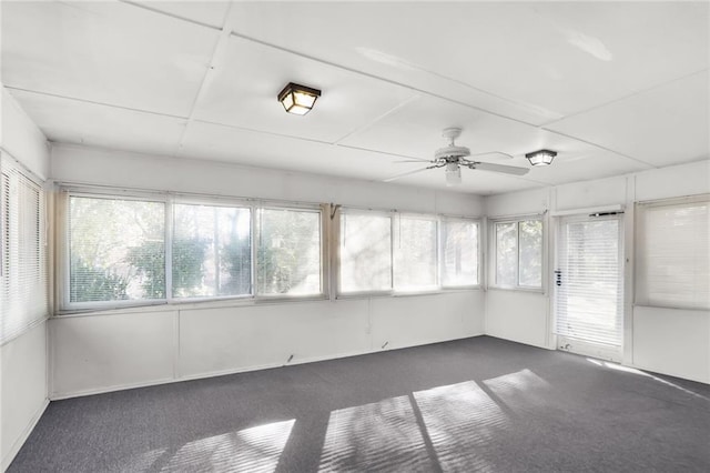 unfurnished sunroom featuring a ceiling fan