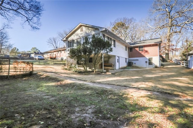 exterior space featuring fence and central AC unit