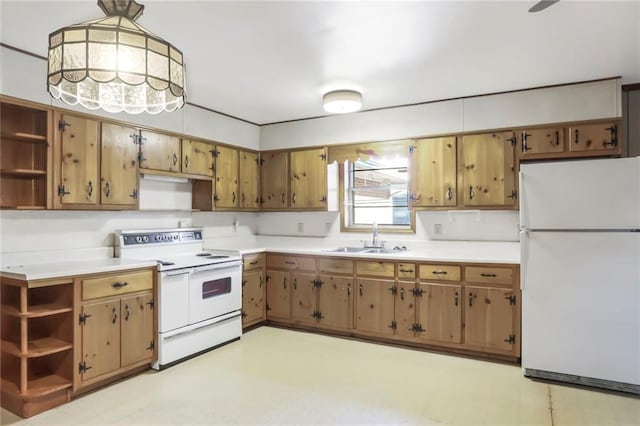 kitchen with hanging light fixtures, white appliances, open shelves, and a sink