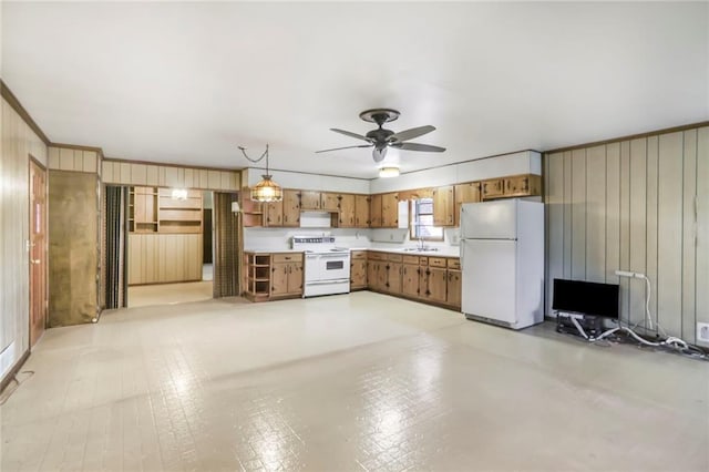 kitchen with white appliances, brown cabinets, light countertops, pendant lighting, and a sink