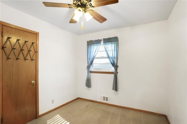 unfurnished room with light carpet, ceiling fan, visible vents, and baseboards