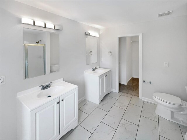 bathroom featuring vanity, toilet, walk in shower, and tile patterned flooring