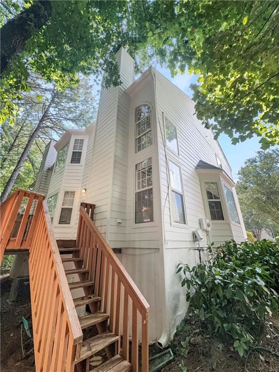 rear view of property featuring a wooden deck