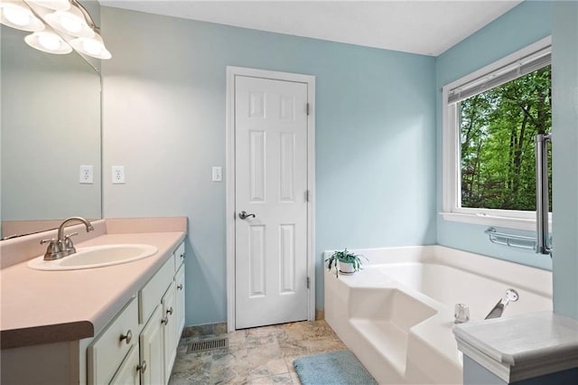 125 Misty Lea Dr, Dallas, GA 30132 - full bathroom featuring vanity, a bath, and stone finish flooring