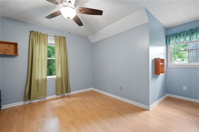 125 Misty Lea Dr, Dallas, GA 30132 - spare room with light wood-type flooring, healthy amount of natural light, a ceiling fan, a textured ceiling, and baseboards