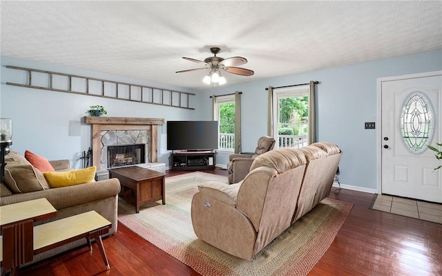 125 Misty Lea Dr, Dallas, GA 30132 - living area featuring wood finished floors, ceiling fan, a textured ceiling, a fireplace, and baseboards
