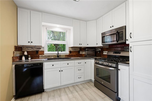 125 Misty Lea Dr, Dallas, GA 30132 - kitchen featuring appliances with stainless steel finishes, a sink, dark countertops, and backsplash
