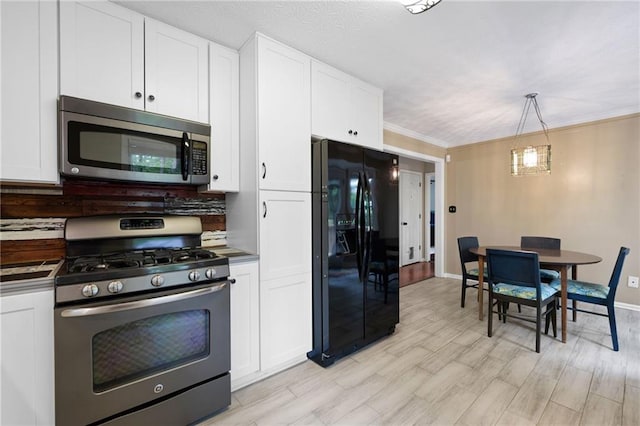 125 Misty Lea Dr, Dallas, GA 30132 - kitchen featuring stainless steel appliances, white cabinetry, tasteful backsplash, and decorative light fixtures