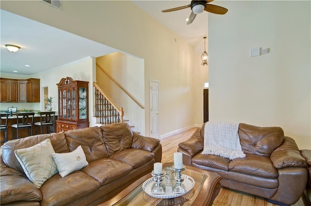 living room with ceiling fan and light hardwood / wood-style floors