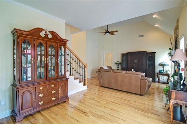 living room featuring ceiling fan, high vaulted ceiling, and light hardwood / wood-style flooring