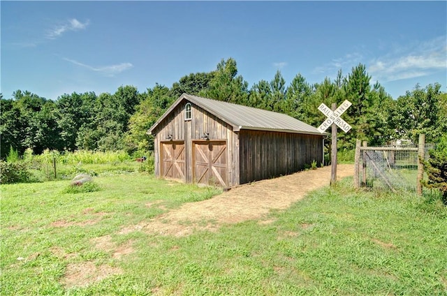 view of outbuilding with a lawn