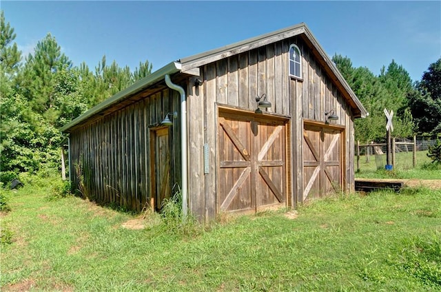 view of outdoor structure featuring a lawn