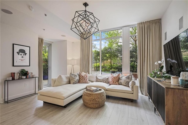 living area featuring a chandelier and light wood-style floors