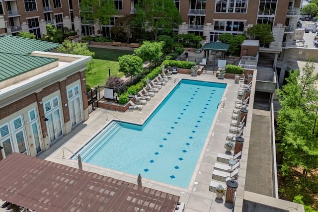 community pool featuring a patio and fence