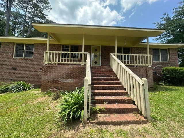 9160 Carr Cir, Covington, GA 30014 - view of front of house featuring brick siding, a front yard, stairway, and crawl space