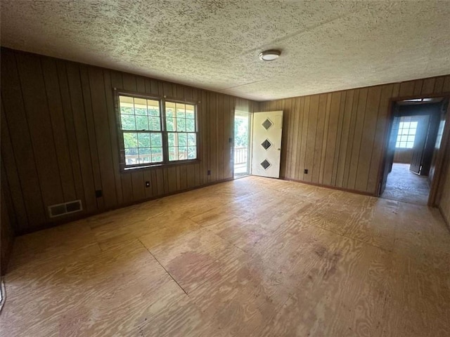 9160 Carr Cir, Covington, GA 30014 - spare room featuring wood walls and a textured ceiling