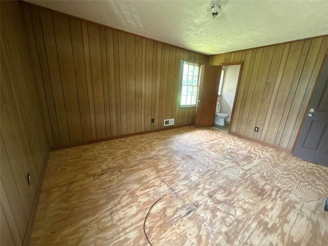 9160 Carr Cir, Covington, GA 30014 - empty room featuring a textured ceiling and wood walls