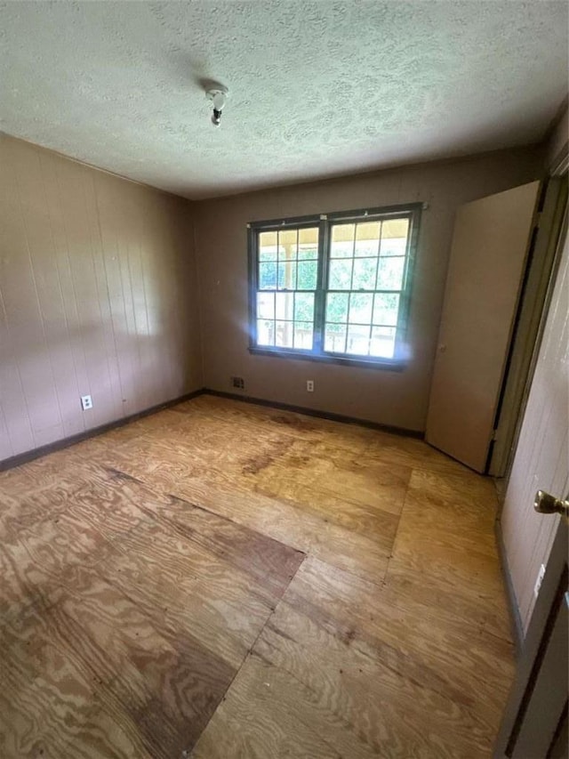 9160 Carr Cir, Covington, GA 30014 - unfurnished room featuring a textured ceiling and wood walls