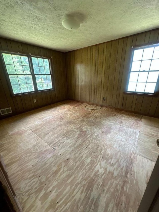 9160 Carr Cir, Covington, GA 30014 - spare room featuring a textured ceiling, wood finished floors, and wood walls