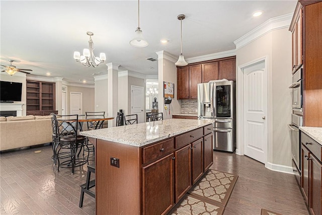 4815 Edgemoore Trce, Cumming, GA 30040 - kitchen with appliances with stainless steel finishes, ceiling fan, open floor plan, a chandelier, and crown molding