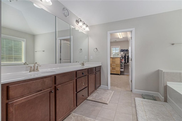4815 Edgemoore Trce, Cumming, GA 30040 - full bath with tile patterned floors, a garden tub, double vanity, baseboards, and a spacious closet