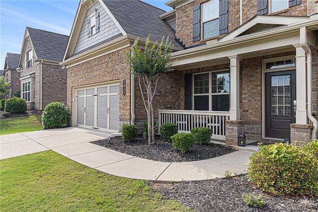 4815 Edgemoore Trce, Cumming, GA 30040 - doorway to property featuring covered porch, concrete driveway, brick siding, and a lawn