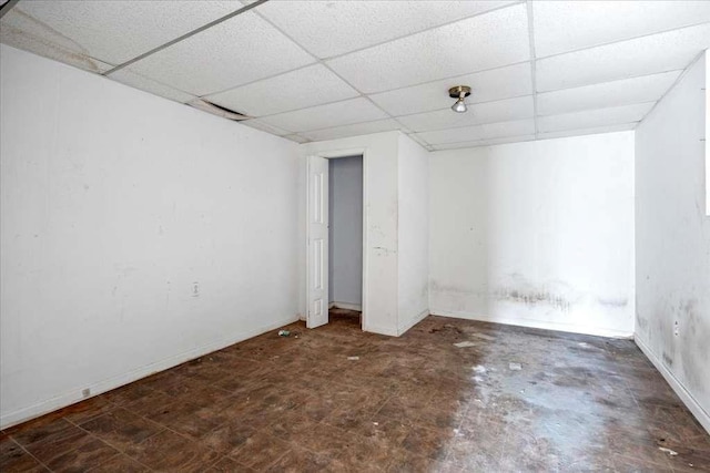 basement with a paneled ceiling