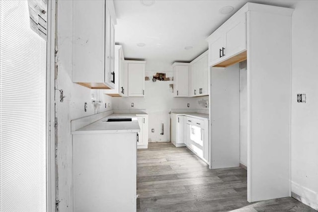 kitchen with white cabinetry and light hardwood / wood-style floors