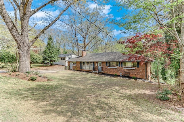 613 Holly Dr, Gainesville, GA 30501 - ranch-style home with a chimney, a front yard, and brick siding
