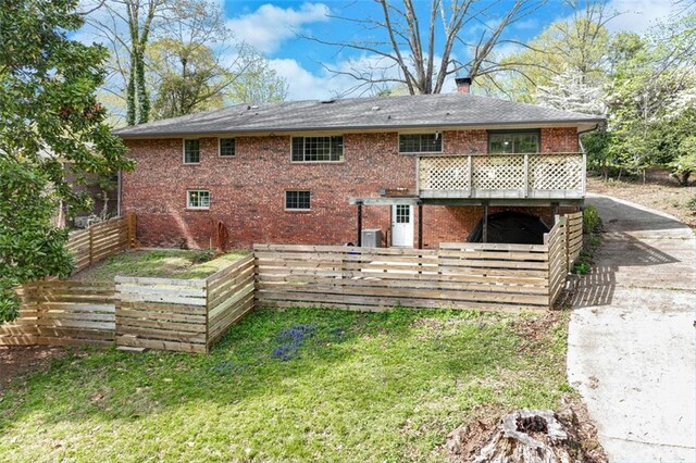 613 Holly Dr, Gainesville, GA 30501 - rear view of property with brick siding, fence, a yard, and a chimney