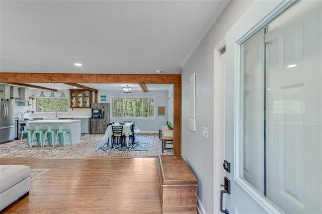 613 Holly Dr, Gainesville, GA 30501 - living room with plenty of natural light, crown molding, beamed ceiling, and light wood finished floors