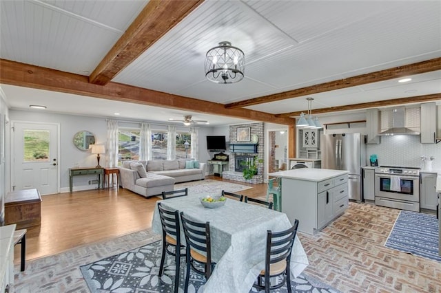613 Holly Dr, Gainesville, GA 30501 - dining room with baseboards, brick floor, ceiling fan with notable chandelier, and beam ceiling