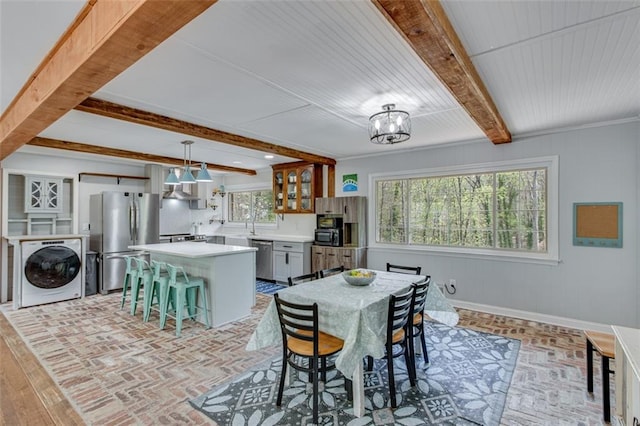 613 Holly Dr, Gainesville, GA 30501 - dining area with a notable chandelier, brick floor, washer / dryer, baseboards, and beamed ceiling