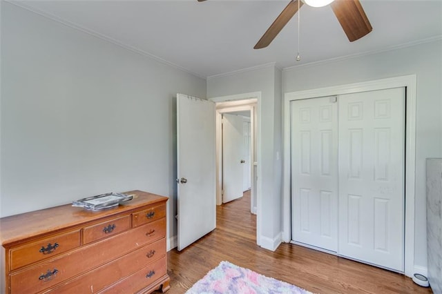 613 Holly Dr, Gainesville, GA 30501 - bedroom with a closet, baseboards, ornamental molding, and wood finished floors