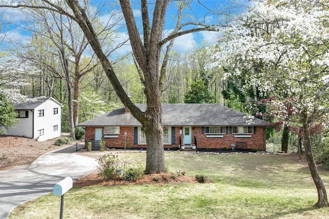 613 Holly Dr, Gainesville, GA 30501 - view of front facade featuring brick siding, concrete driveway, an outdoor structure, and a front yard