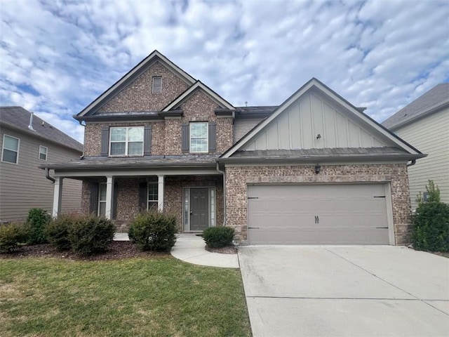 craftsman-style house featuring a front yard, a garage, and covered porch