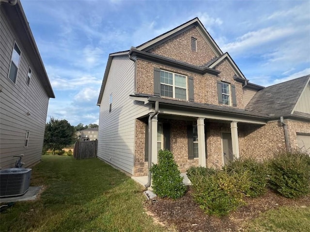 craftsman-style home with central AC and a front yard