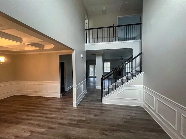 entrance foyer with a towering ceiling, dark hardwood / wood-style floors, and ceiling fan