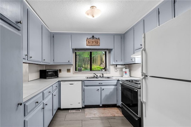 200 Villa Rd Unit 125, Jasper, GA 30143 - kitchen featuring white appliances, a sink, a textured ceiling, light countertops, and gray cabinetry