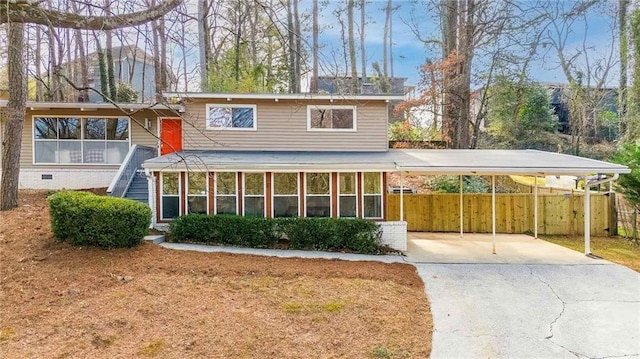 view of front of property featuring a sunroom and a carport