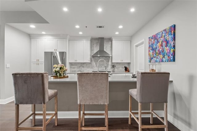 270 17th St NW Unit 2804, Atlanta, GA 30363 - kitchen featuring wall chimney range hood, high end refrigerator, recessed lighting, white cabinetry, and light countertops