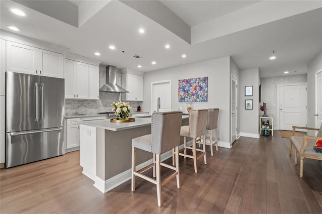 270 17th St NW Unit 2804, Atlanta, GA 30363 - kitchen with high quality fridge, wall chimney range hood, light countertops, recessed lighting, and wood finished floors