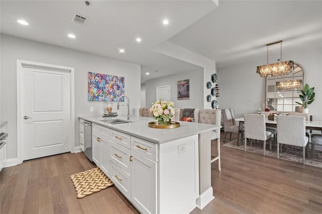 270 17th St NW Unit 2804, Atlanta, GA 30363 - kitchen with a peninsula, white cabinets, wood finished floors, light countertops, and stainless steel dishwasher