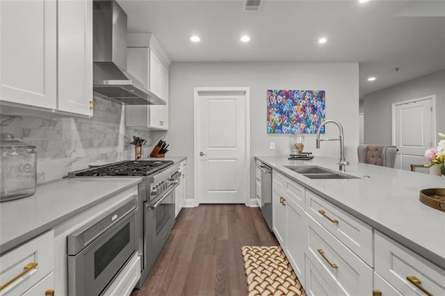 270 17th St NW Unit 2804, Atlanta, GA 30363 - kitchen with wall chimney range hood, stainless steel appliances, light countertops, dark wood finished floors, and backsplash