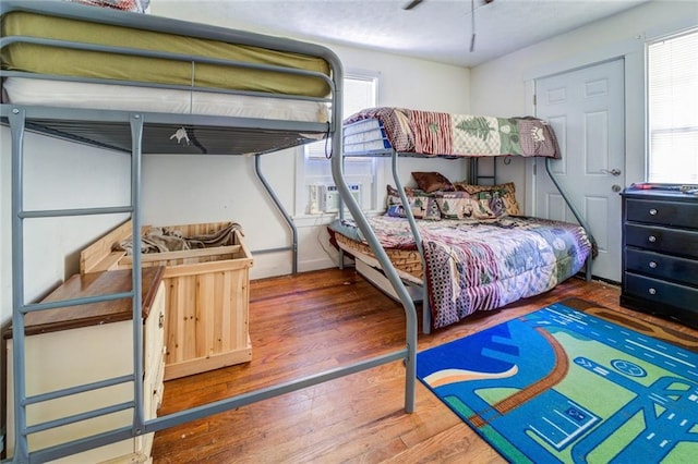 bedroom featuring multiple windows and hardwood / wood-style floors