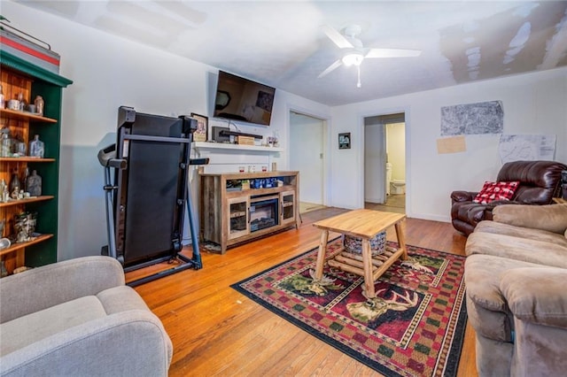 living room with hardwood / wood-style flooring and ceiling fan