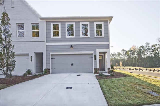 view of front facade with a front yard and a garage