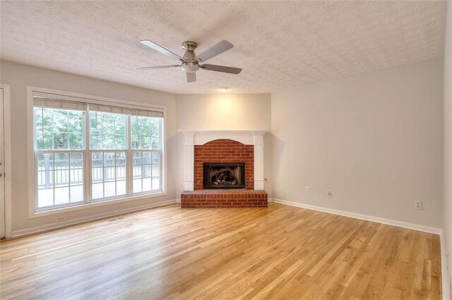 662 Shady Willow Ln, Loganville, GA 30052 - unfurnished living room featuring a textured ceiling, light wood finished floors, baseboards, recessed lighting, and ceiling fan