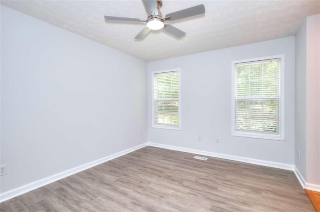 662 Shady Willow Ln, Loganville, GA 30052 - spare room with wood finished floors, a textured ceiling, baseboards, and a ceiling fan